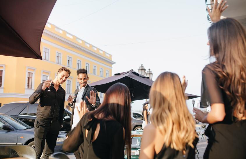 young guests enjoying a party with event security in the background