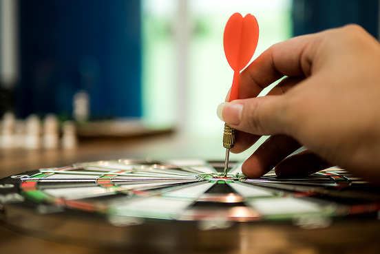 a dart held against a dartboard